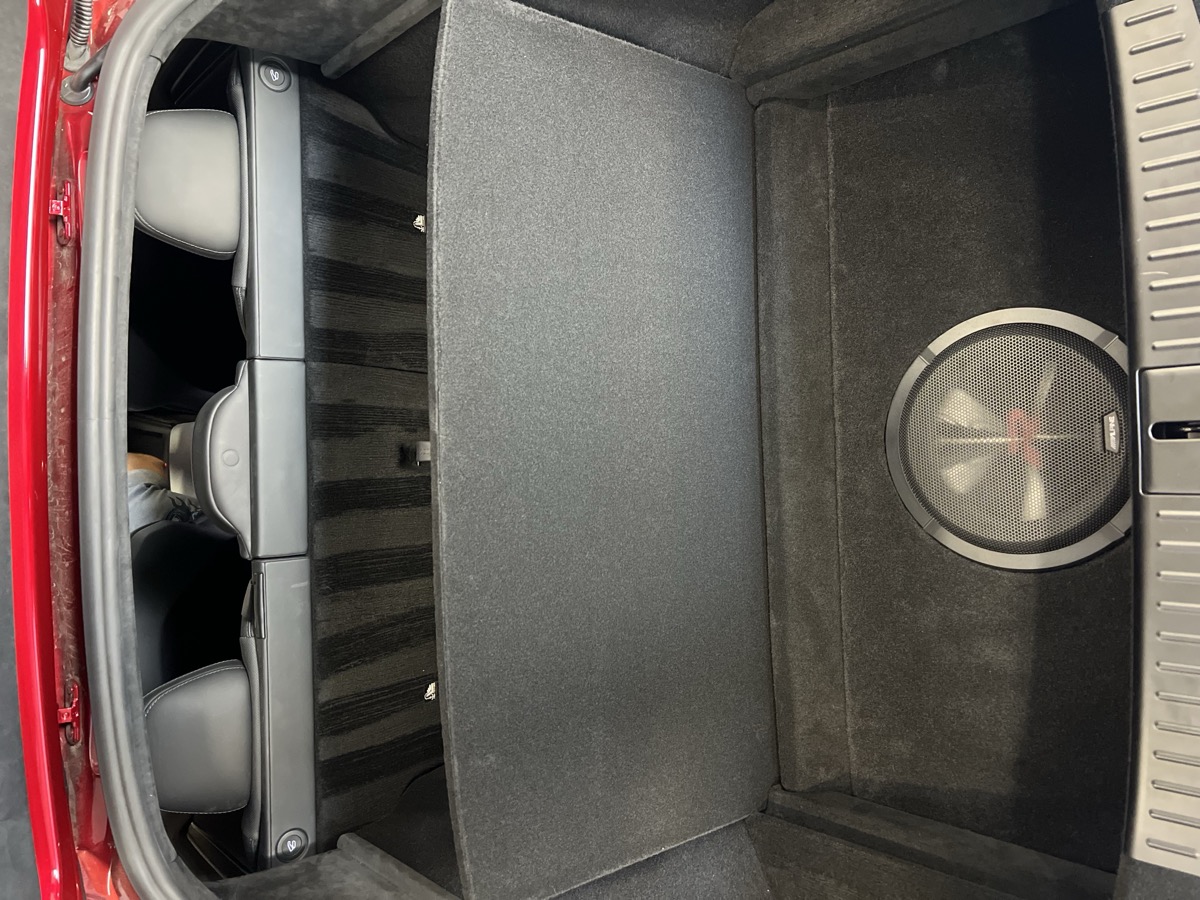 Custom carpeted Alpine subwoofer enclosure flush-mounted in trunk – Car Plus Merced trunk restoration